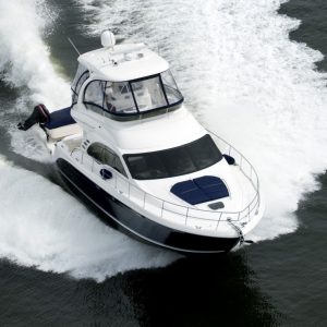 A blue and white speedboat shot from above while travelling fast.